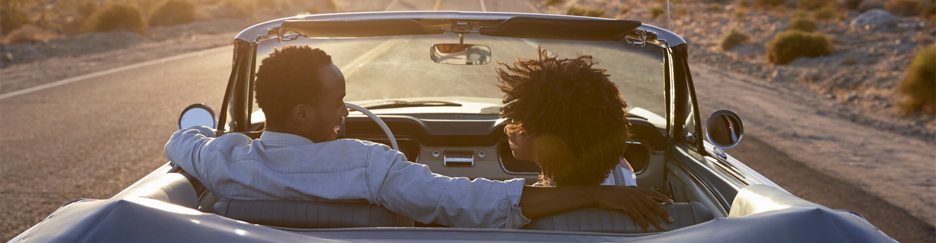 Two people riding on convertible