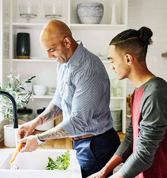 Father is cooking dinner with his son