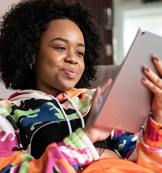 A young girl uses a tablet