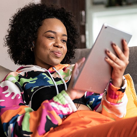 A young girl uses a tablet